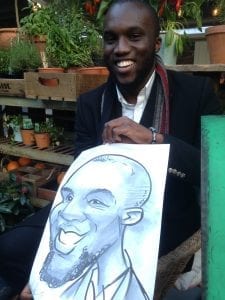 Man in black jacket laughing with caricature by Allan Cavanagh
