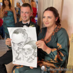 Seated man in black bow-tie and woman in green dress at a wedding drinks reception in Armada Hotel Spanish Point County Clare