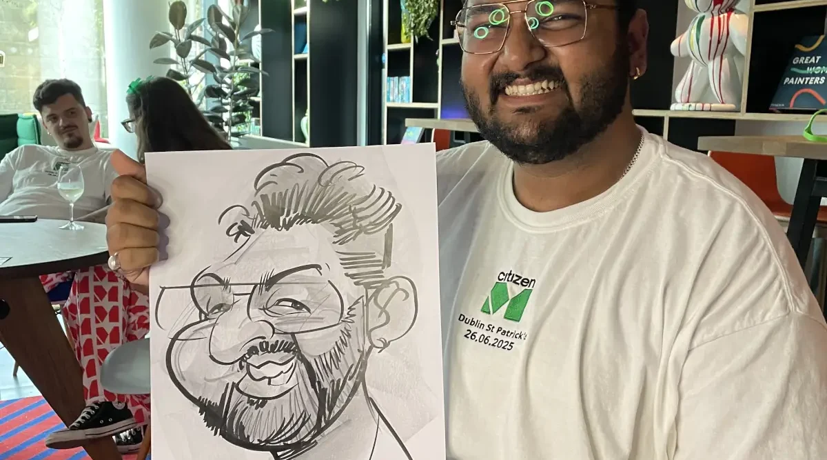 Citizen M Hotel Dublin Staff Party man holding caricature of himself and laughing