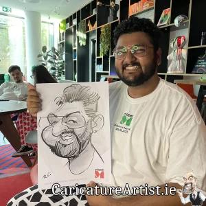 Citizen M Hotel Dublin Staff Party man holding caricature of himself and laughing