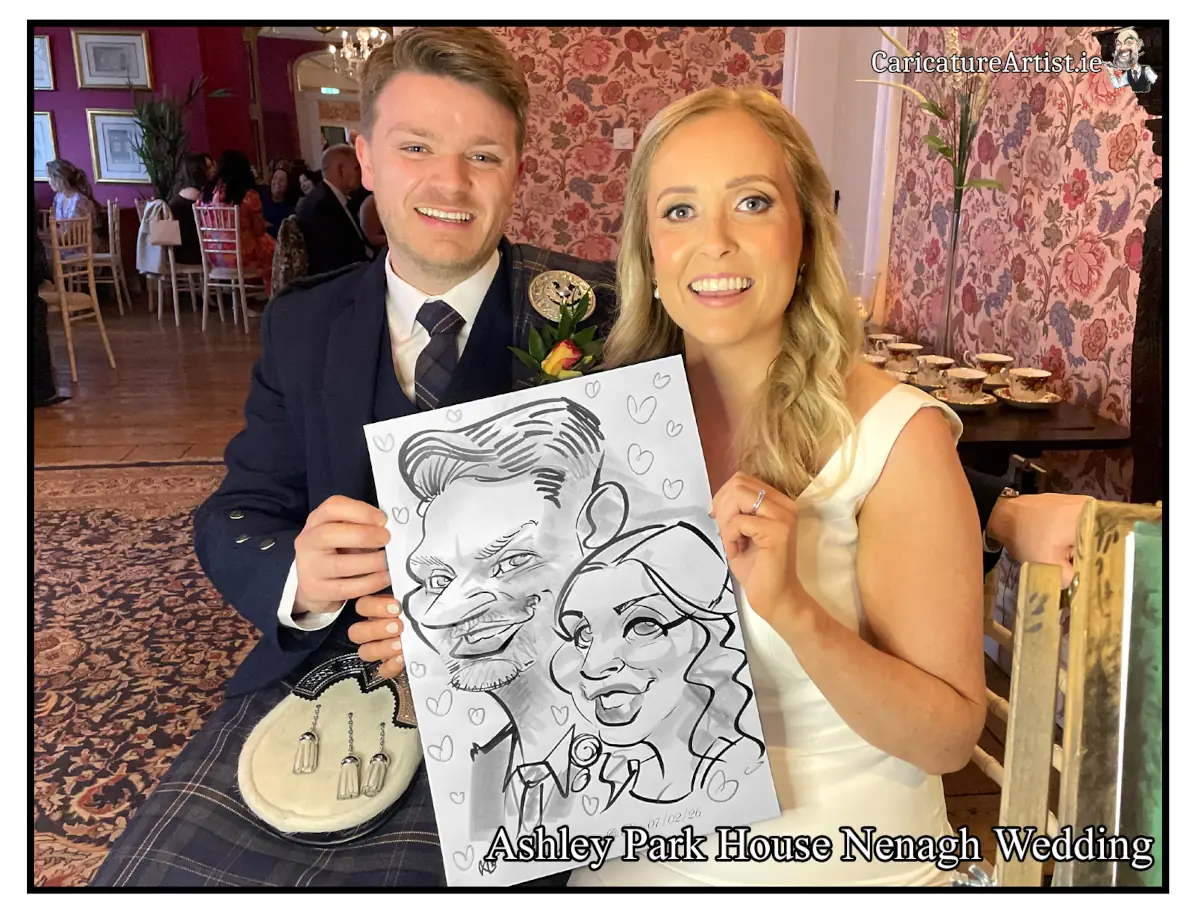 Newlywed Couple holding caricature by Allan Cavanagh in Ashley Park House Nenagh Wedding Photos Live Caricatures Allan Cavanagh Caricature Artist