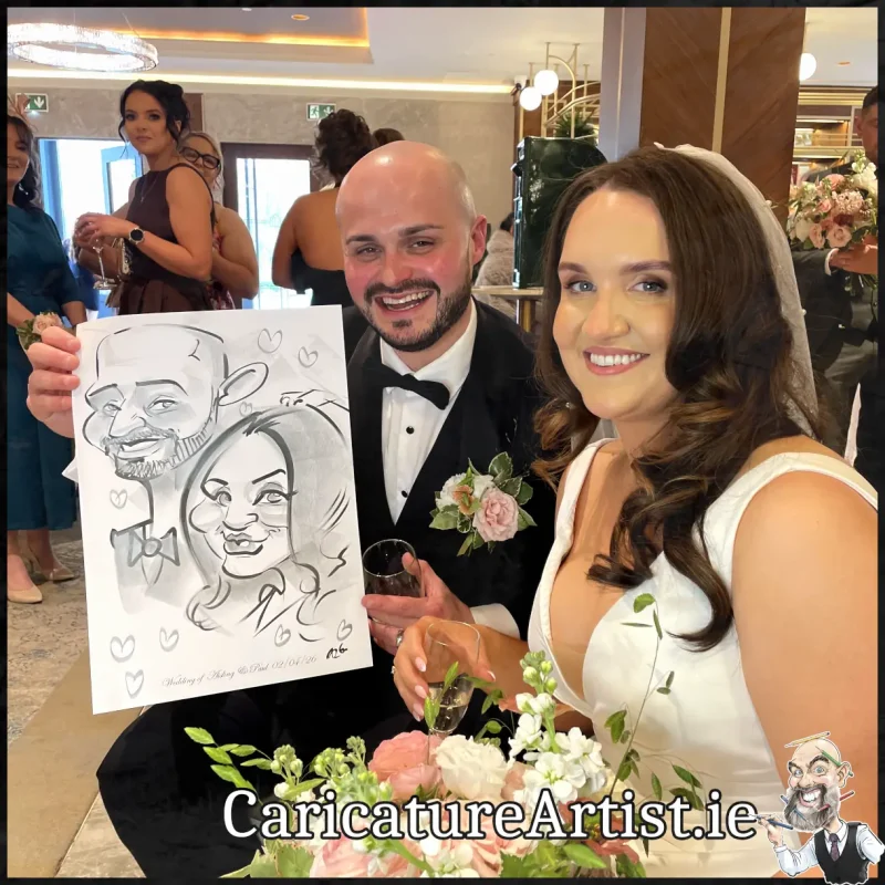 Johnstown Estate Wedding Entertainment wedding guests laughing holding Allan Cavanagh Caricatures (1) Copy