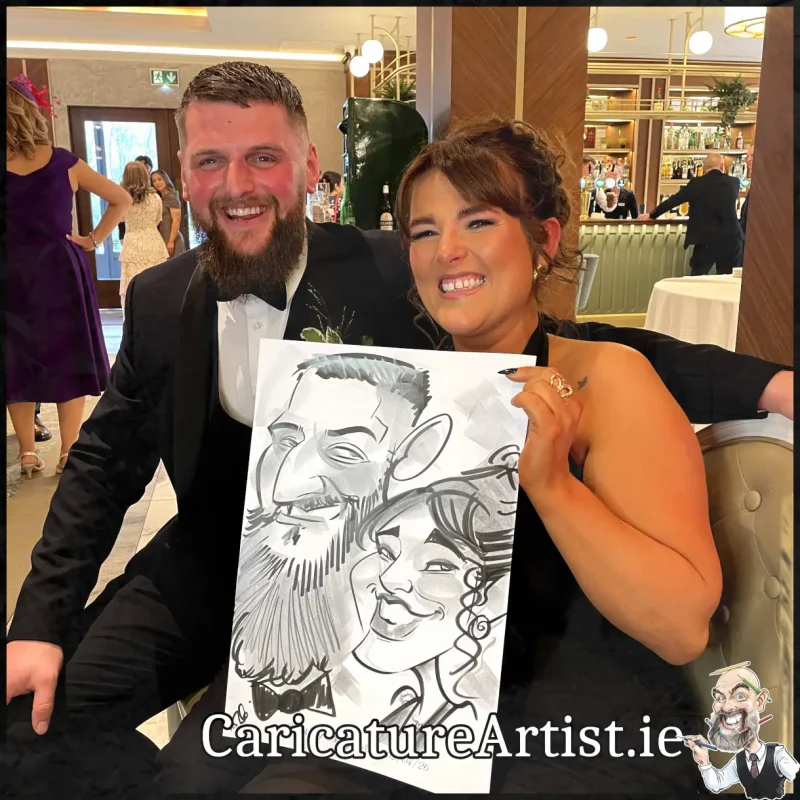 Johnstown Estate Wedding Entertainment wedding guests laughing holding Allan Cavanagh Caricatures (12) Copy