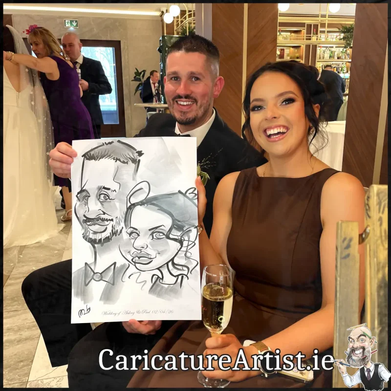 Johnstown Estate Wedding Entertainment wedding guests laughing holding Allan Cavanagh Caricatures (13) Copy
