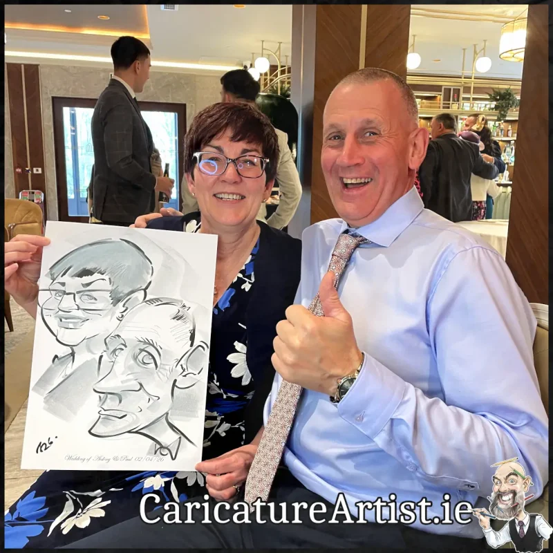 Johnstown Estate Wedding Entertainment wedding guests laughing holding Allan Cavanagh Caricatures (2) Copy