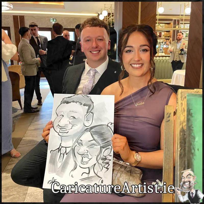 Johnstown Estate Wedding Entertainment wedding guests laughing holding Allan Cavanagh Caricatures (3) Copy