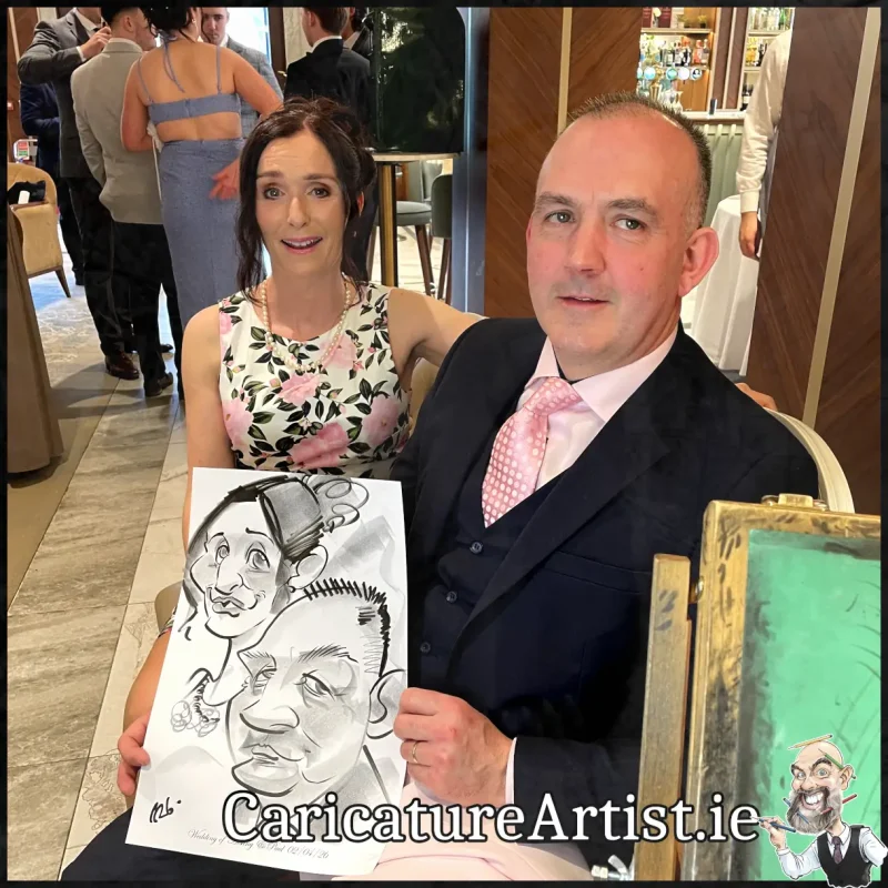 Johnstown Estate Wedding Entertainment wedding guests laughing holding Allan Cavanagh Caricatures (4) Copy