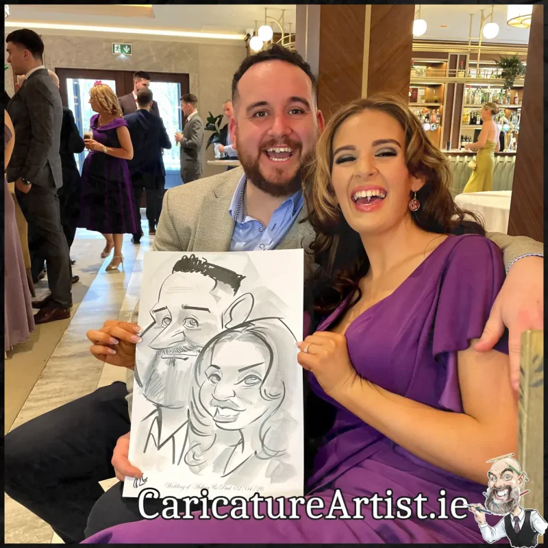 Johnstown Estate Wedding Entertainment wedding guests laughing holding Allan Cavanagh Caricatures (7) Copy