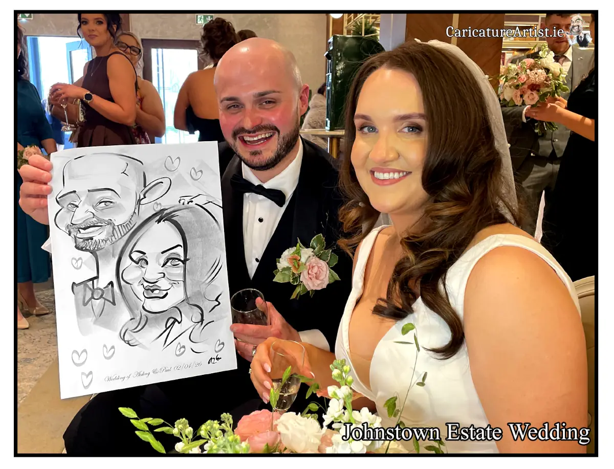 Johnstown Estate Wedding Entertainment wedding guests laughing holding Allan Cavanagh Caricatures featured image
