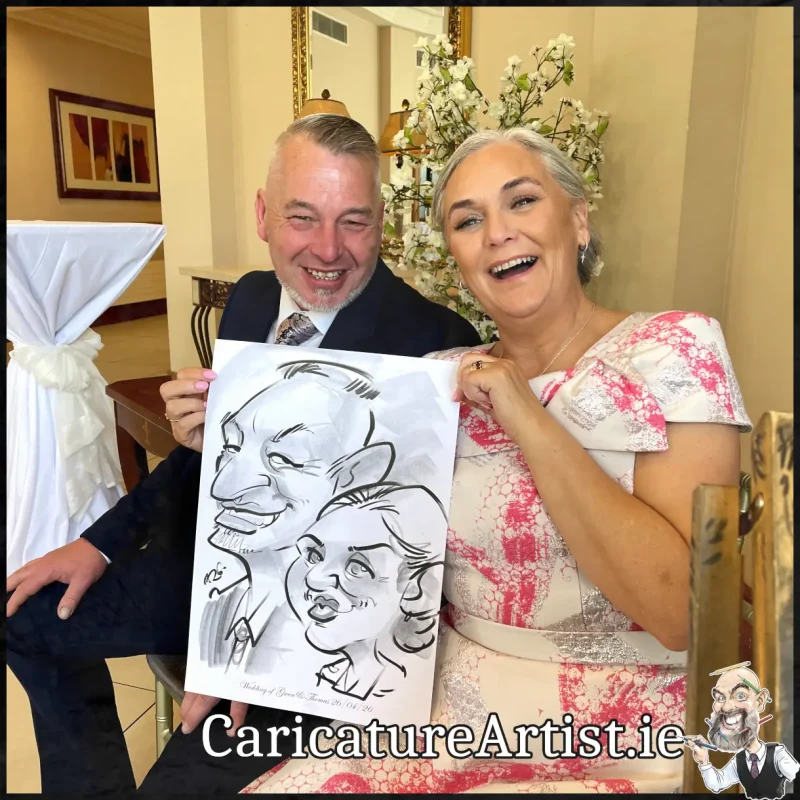 Mount Wolseley Wedding Entertainment 2 wedding guests laughing holding caricatures by Allan Cavanagh (10)