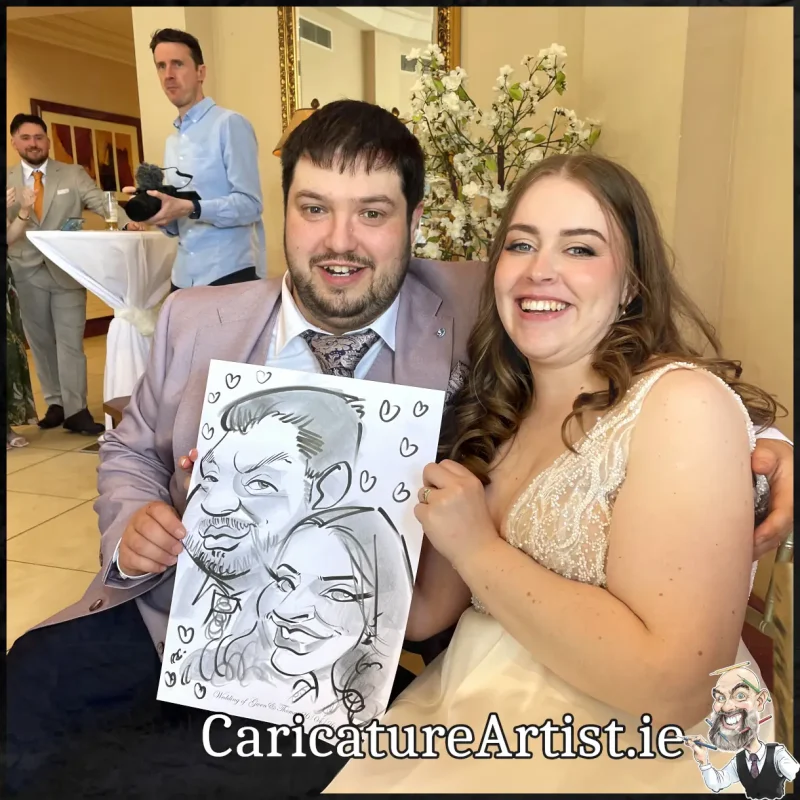 Mount Wolseley Wedding Entertainment 2 wedding guests laughing holding caricatures by Allan Cavanagh (11)