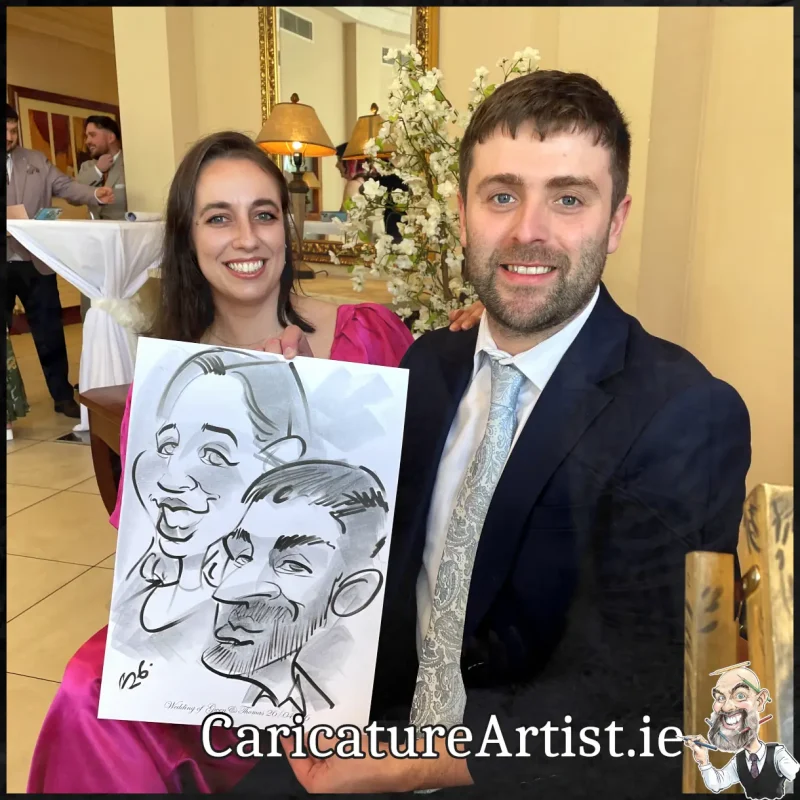 Mount Wolseley Wedding Entertainment 2 wedding guests laughing holding caricatures by Allan Cavanagh (12)