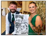 Mount Wolseley Wedding Entertainment 2 wedding guests laughing holding caricatures by Allan Cavanagh