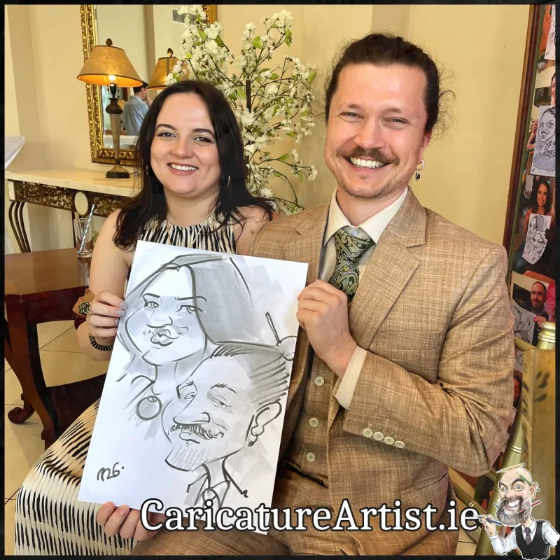 Mount Wolseley Wedding Entertainment 2 wedding guests laughing holding caricatures by Allan Cavanagh (17)