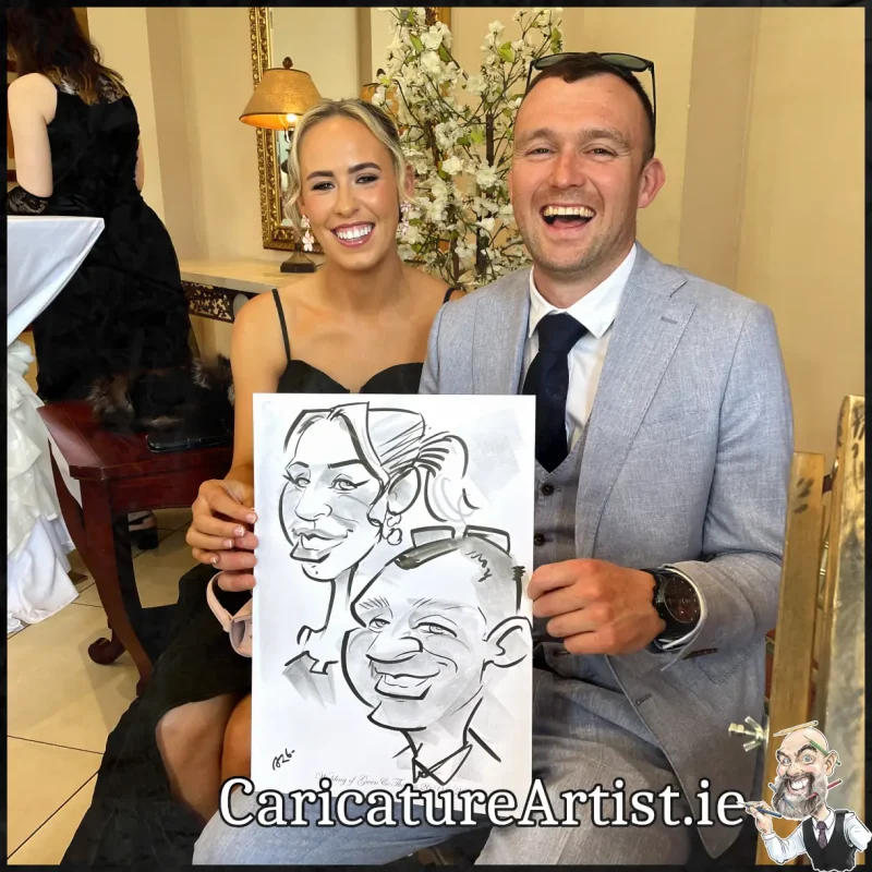Mount Wolseley Wedding Entertainment 2 wedding guests laughing holding caricatures by Allan Cavanagh (2)