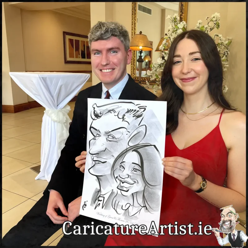 Mount Wolseley Wedding Entertainment 2 wedding guests laughing holding caricatures by Allan Cavanagh (5)