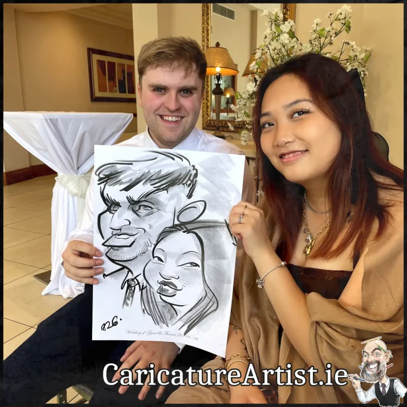Mount Wolseley Wedding Entertainment 2 wedding guests laughing holding caricatures by Allan Cavanagh (6)