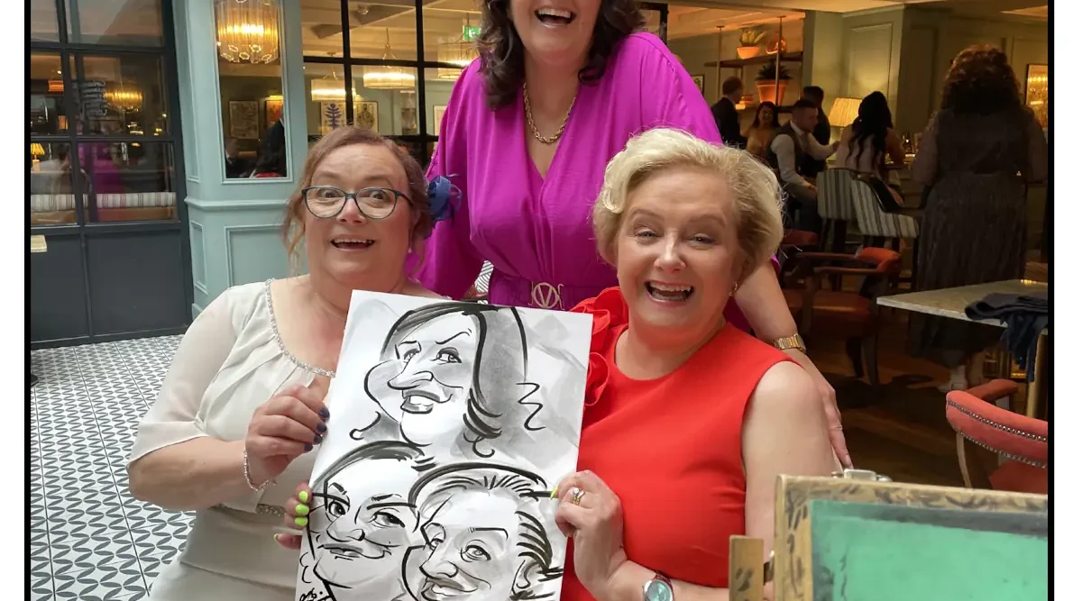 Best Letterkenny Wedding Entertainment Caricatures for Weddings by Allan Cavanagh in Mount Errigal Hotel Donegal. Image shows three women laughing and holding caricatures by Donegal Caricature Artist Allan Cavanagh