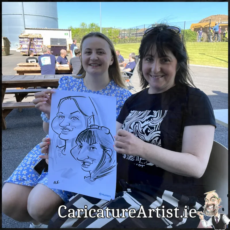 Staff Summer Party Entertainment Ireland Caricatures by Allan Cavanagh Cork Photo of 2 people holding caricature drawing of themselves(21)