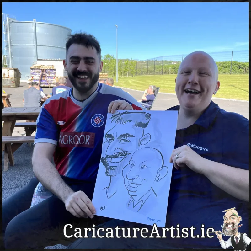 Staff Summer Party Entertainment Ireland Caricatures by Allan Cavanagh Cork Photo of 2 people holding caricature drawing of themselves(22)