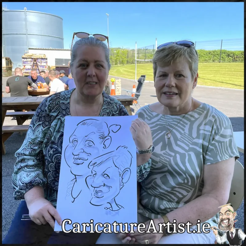 Staff Summer Party Entertainment Ireland Caricatures by Allan Cavanagh Cork Photo of 2 people holding caricature drawing of themselves(28)