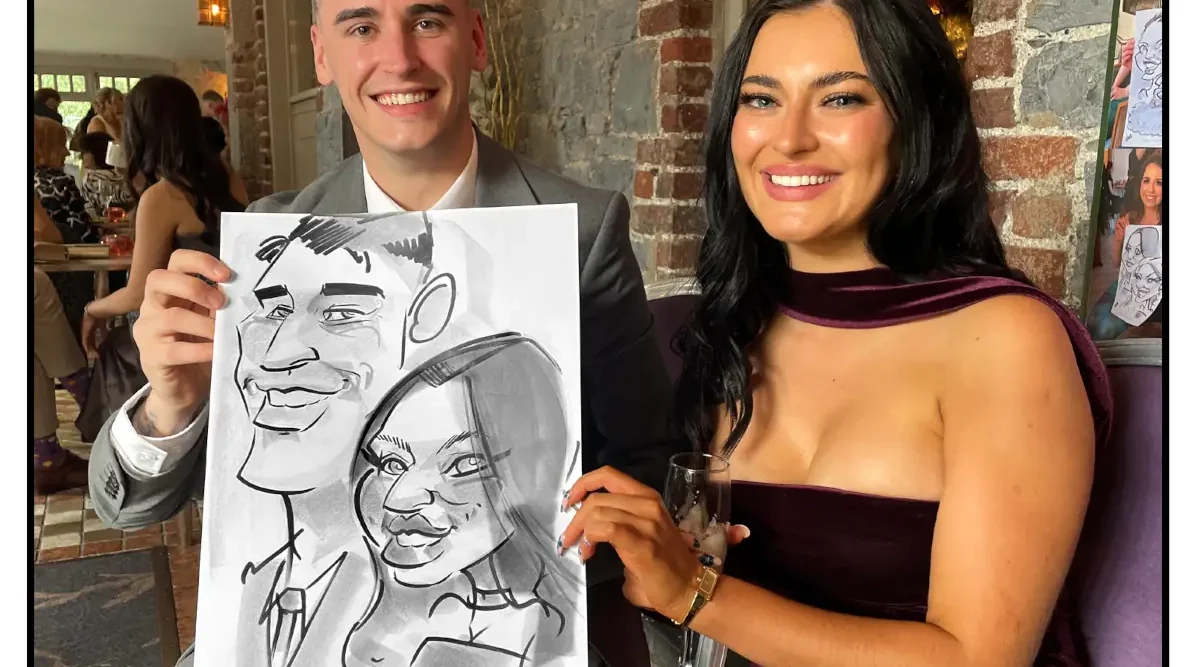 Hotel Kilkenny Wedding Entertainment Caricatures Irelands top rated caricature artist Allan Cavanagh photo of male and female wedding guests at a wedding holding a caricature of themselves by Allan Cavanagh