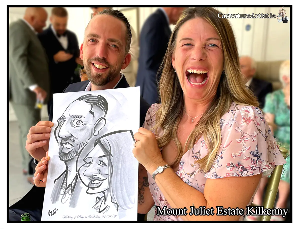 Mount Juliet Weddings Live Caricature Drawing of wedding guests by Irelands top rated caricaturist Allan Cavanagh. Image is a photograph of a laughing man and woman holding a caricature of themselves at a wedding reception in Mount Juliet Kilkenny